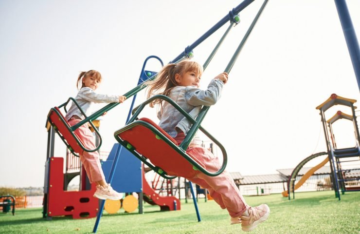 enjoying-swing-ride-kids-are-having-fun-playground_Easy-Resize.com
